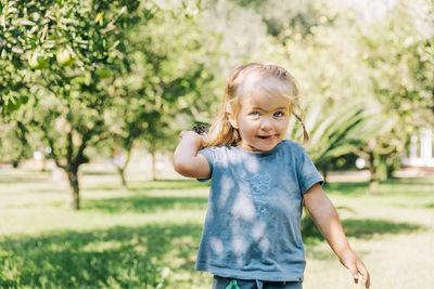 Portrait of a girl standing on field