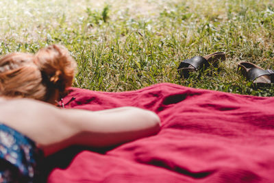 Close-up of woman relaxing on grass