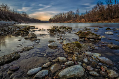 Scenic view of river at sunset