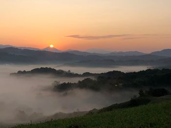 Scenic view of mountains against sky during sunset