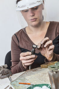 Woman making jewelry in workshop