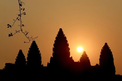 Silhouette temple against sky during sunset