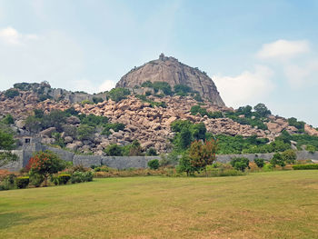 Scenic view of land and mountains against sky