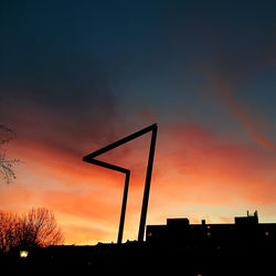 Silhouette of building against dramatic sky