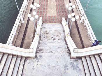 High angle view of ladder on pier by sea