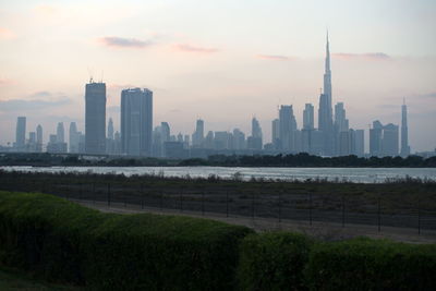 View of buildings in city against sky during sunset