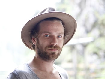 Close-up portrait of man wearing sun hat