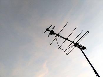 Low angle view of silhouette airplane against sky