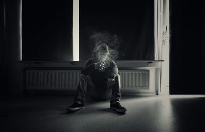 Portrait of man smoking indoors