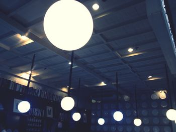 Low angle view of illuminated lights at night