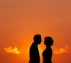 Silhouette of two persons in sunset, love and dancing, having fun.