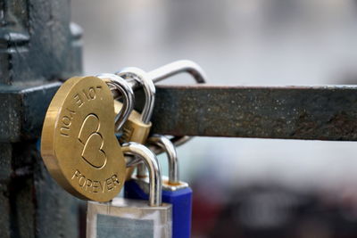 Close-up of padlocks on metal railing