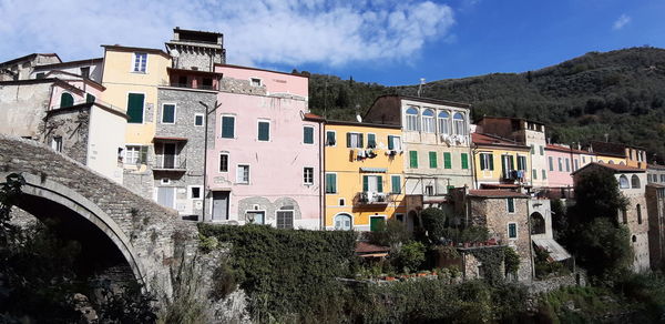 Buildings in town against sky