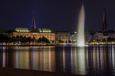 Illuminated city at waterfront