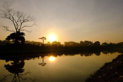 Scenic view of lake against sky during sunset