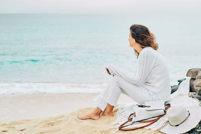 Woman sitting on beach
