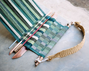 High angle view of mat being weaved on floor