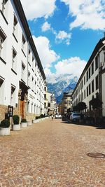 Street amidst buildings in city against sky