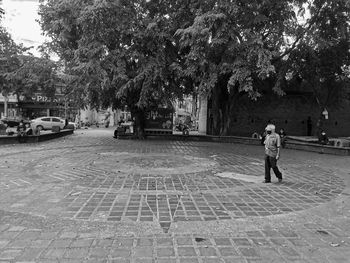 Rear view of man walking on street in city