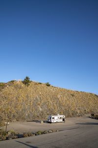 Car on road against clear sky