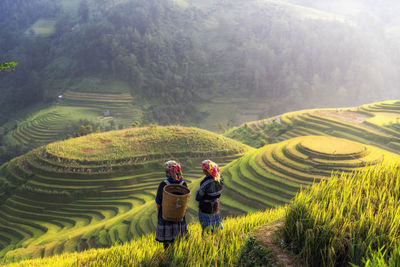 Panoramic view of people relaxing on field