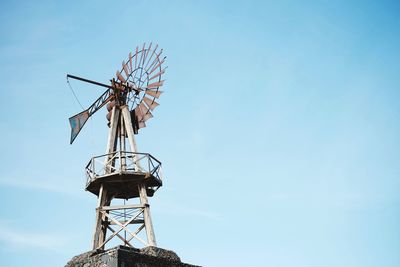 Traditional windmill against blue sky