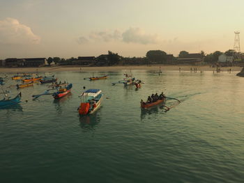 Panoramic view of people on river against sky