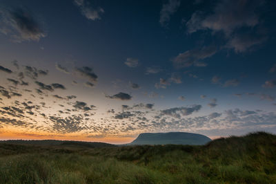 Scenic view of field against sky during sunset