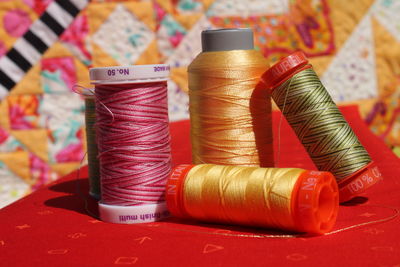 Close-up of thread spools on table