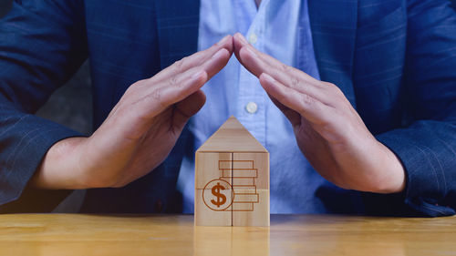 Midsection of man holding toy blocks on table