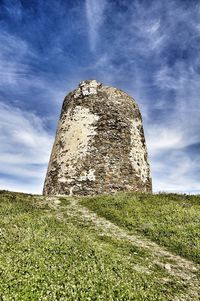Low angle view of castle on field against sky