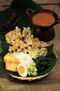 Nasi pecel.traditional javanese rice dish of steamed rice with vegetable salad peanut sauce dressing