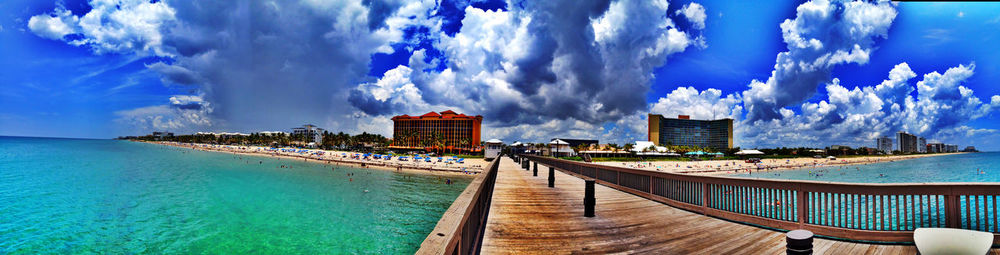 Panoramic view of calm sea with buildings in background