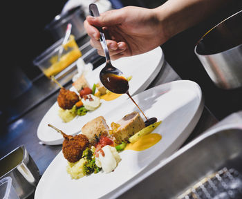 Cropped hand of person preparing food