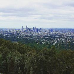 Cityscape against cloudy sky