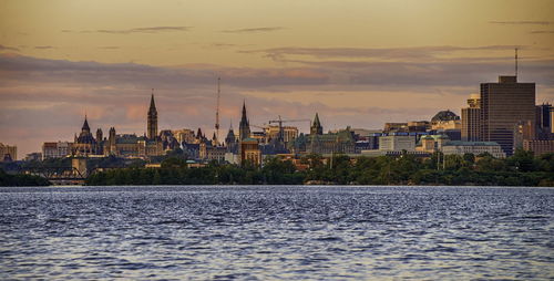 River with buildings in background at sunset at ottawa