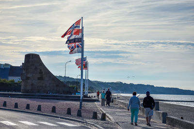 People on beach against sky