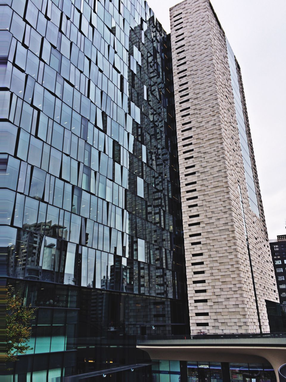 building exterior, architecture, built structure, low angle view, city, office building, modern, skyscraper, building, tall - high, glass - material, window, sky, city life, tower, residential building, day, outdoors, reflection, no people