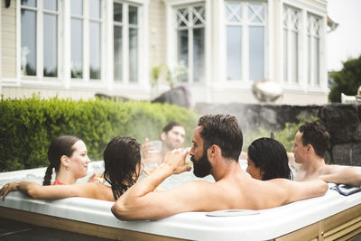 Group of people relaxing in swimming pool