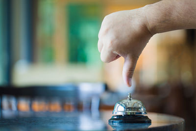 Close-up of person holding ice cream on table