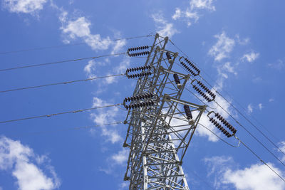 Low angle view of electricity pylon against sky