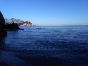 Scenic view of sea against clear blue sky