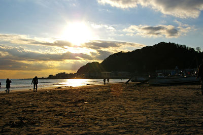 Scenic view of beach against sky during sunset