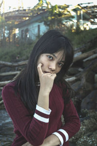 Portrait of a young woman sitting outdoors