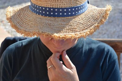 Close-up of man wearing sun hat