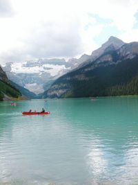Scenic view of lake and mountains against sky