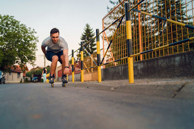 Full length of man roller skating on road