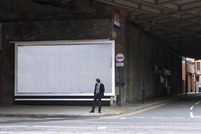 Full length of a person walking on road in city