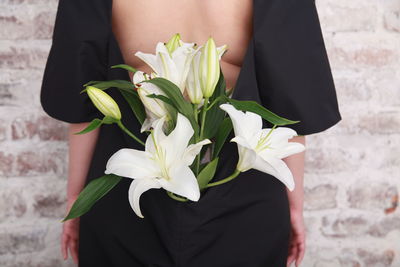 Midsection of woman holding bouquet