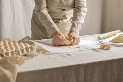 Midsection of woman holding food on table